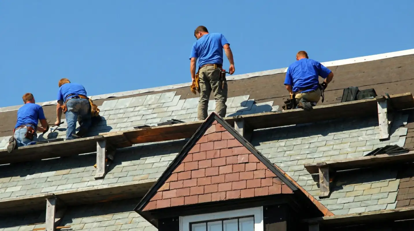 Roof replacement in progress with a team of professional contractors installing new shingles on a residential home in Boulder, CO